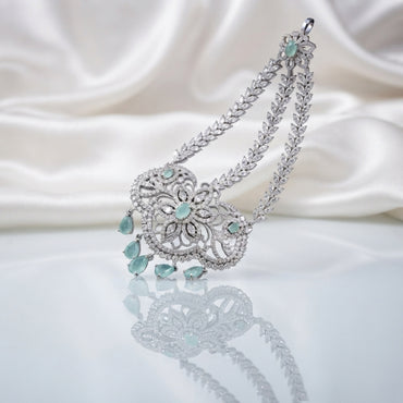 Silver Mint Green CZ Floral Filigree and Marquise Wheat Chain Grand Maang Tikka on white satin backdrop showing rhodium silver double-strand marquise white CZ wheat chain with 3-medallion open filigree flower pendant mint green CZ accents and graduated mint green pear drop fringe