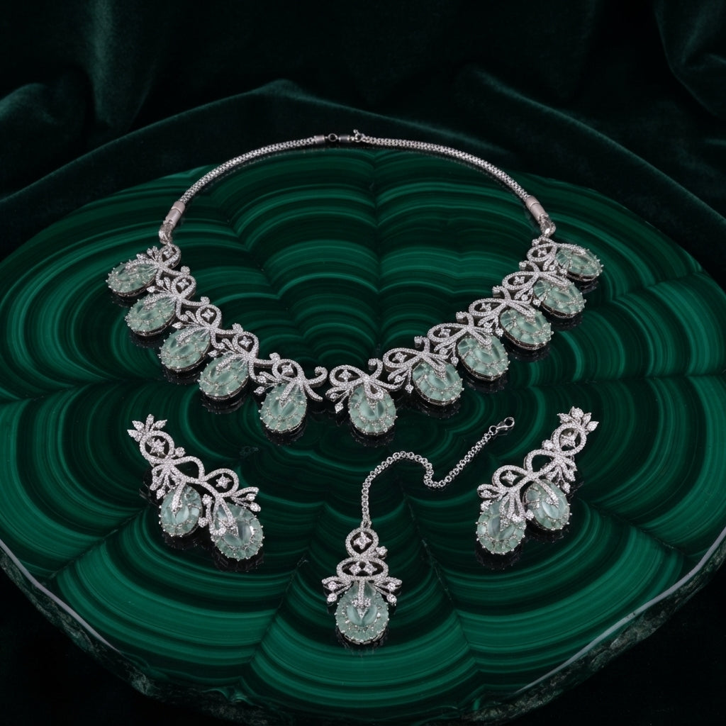 Silver-Tone Mint Jade Green Oval Cabochon & White CZ Pavé Arabesque Vine Leaf Choker Necklace Drop Earrings & Maang Tikka 3-Piece Bridal Set on malachite green stone tray with dark green velvet backdrop