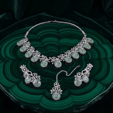Silver-Tone Mint Jade Green Oval Cabochon & White CZ Pavé Arabesque Vine Leaf Choker Necklace Drop Earrings & Maang Tikka 3-Piece Bridal Set on malachite green stone tray with dark green velvet backdrop