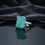 Silver Paraiba Teal Raw Crackle Emerald-Cut CZ Statement Cocktail Ring on dark grey mirror surface with charcoal velvet drape backdrop