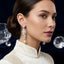 Silver-Tone Pearl & CZ Cascading Wave Long Drop Earrings worn by model against dark blue velvet background