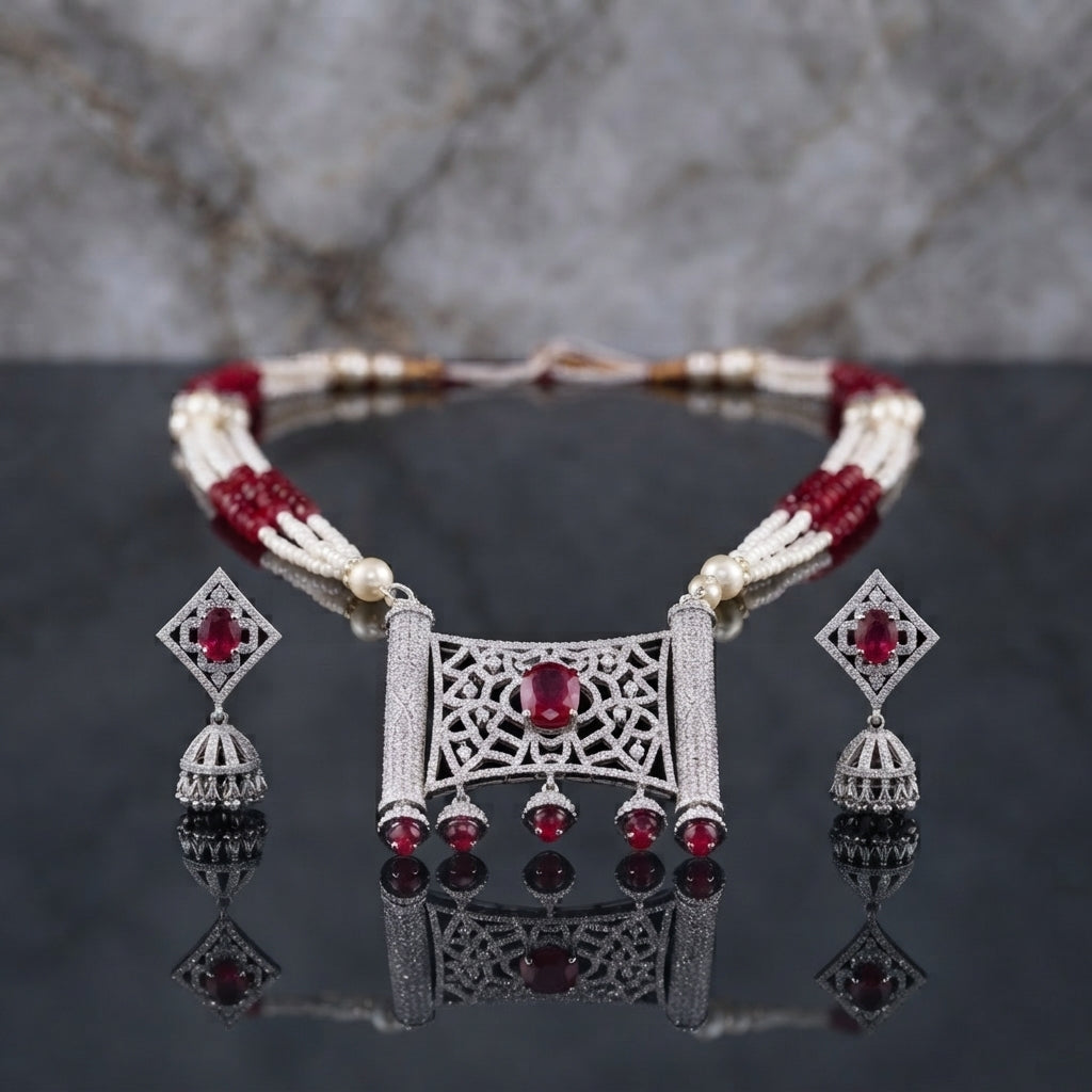 Silver Pearl CZ Mughal Scroll Jali Choker and Jhumka Earrings Set detail flat lay shot showing multi-strand pearl choker with Mughal arabesque jali CZ pave pendant and hanging jhumka drops on dark marble surface