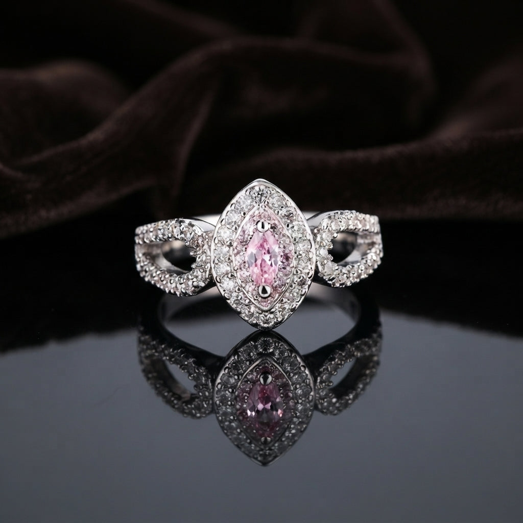 Silver Pink Marquise CZ Double Halo Infinity Twist Band Bridal Ring on dark grey mirror surface with dark brown branches backdrop