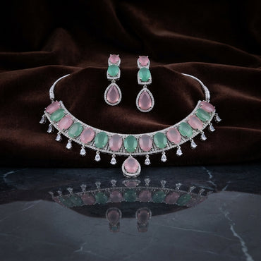 Silver Pink & Mint Green Cabochon CZ Torque Necklace & Drop Earrings Bridal Set on dark grey marble surface with dark brown velvet drape backdrop