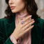 Silver-Tone Pink Pear CZ Multi-Cut Cluster Halo Cocktail Ring worn by model with green velvet blazer