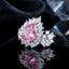Silver-Tone Pink Pear CZ Multi-Cut Cluster Halo Cocktail Ring close-up on dark reflective surface