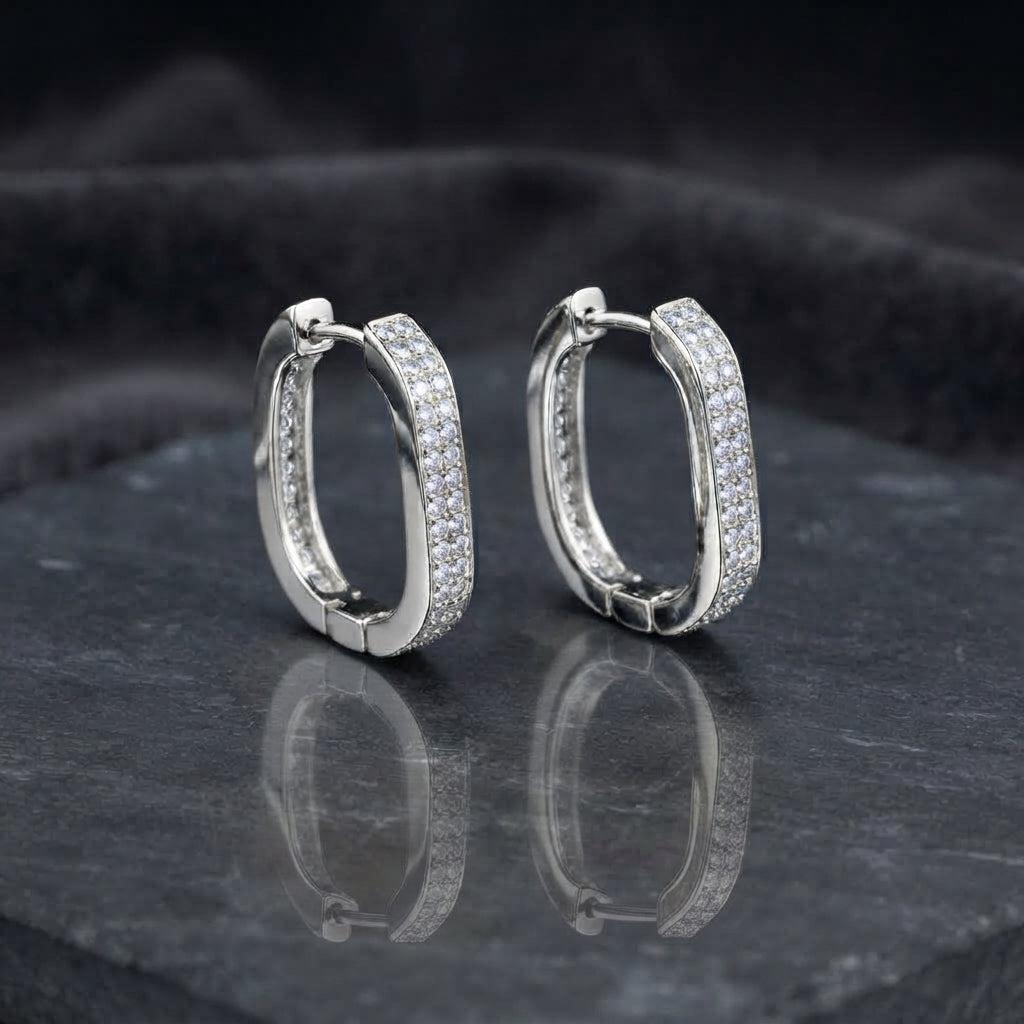 Gold-tone rounded-rectangle hoop earrings with pavé-style clear stones.