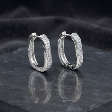 Gold-tone rounded-rectangle hoop earrings with pavé-style clear stones.