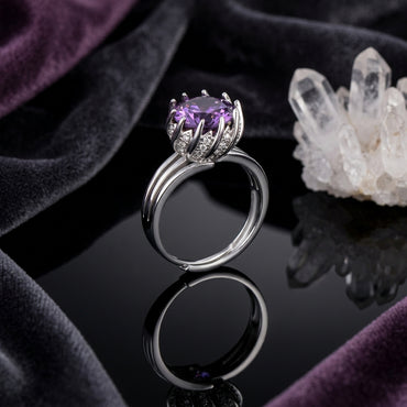 Silver-Tone Round Amethyst Purple CZ Lotus Crown Claw Solitaire & White CZ Pavé Shoulder Triple Band Ring on black mirror surface with white crystal quartz cluster and deep purple velvet backdrop