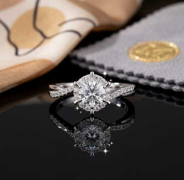Silver-Tone Round CZ Floral Halo & Pavé Chevron Band Solitaire Engagement Ring front view on black reflective surface with gold seal stamp and gray velvet polishing cloth backdrop