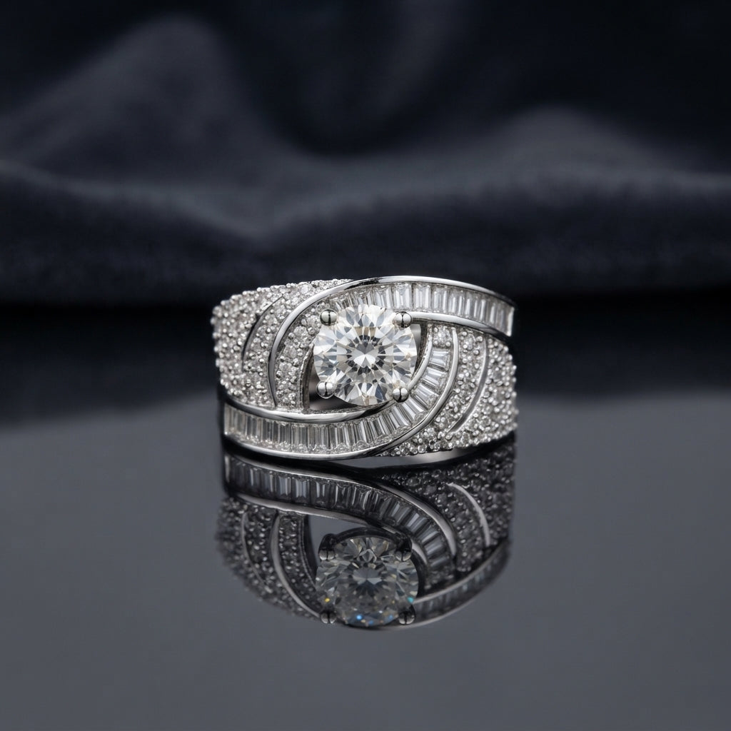 Silver Round CZ Solitaire Baguette Swirl Wide Band Statement Cocktail Ring on dark mirror surface with charcoal satin backdrop showing large round brilliant clear CZ solitaire in 6-claw setting within asymmetric crossing swirl arms fully set with 2-row channel-set baguette CZ outer arm and dense micro-pave round white CZ inner arm in rhodium silver with mirror reflection below