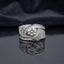 Silver Round CZ Solitaire Baguette Swirl Wide Band Statement Cocktail Ring on dark mirror surface with charcoal satin backdrop showing large round brilliant clear CZ solitaire in 6-claw setting within asymmetric crossing swirl arms fully set with 2-row channel-set baguette CZ outer arm and dense micro-pave round white CZ inner arm in rhodium silver with mirror reflection below