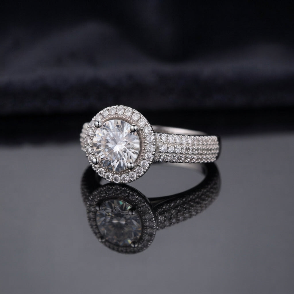 Silver Round CZ Solitaire Double Halo Triple Pave Split Shank Engagement Ring worn on ring finger of female model in navy blue blazer and white top in luxury jewelry boutique backdrop showing large round brilliant clear CZ solitaire with double round white CZ halo and triple-row micro-pave split shank band in rhodium silver