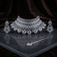 Silver Royal Blue Sapphire CZ Grand Bib Choker Drop Earrings & Maang Tikka Grand Bridal Set on dark grey mirror surface with dark brown velvet drape backdrop