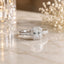Silver-Tone Asscher-Cut CZ Halo Pavé Band Bridal Engagement Ring product shot on marble surface with floral backdrop