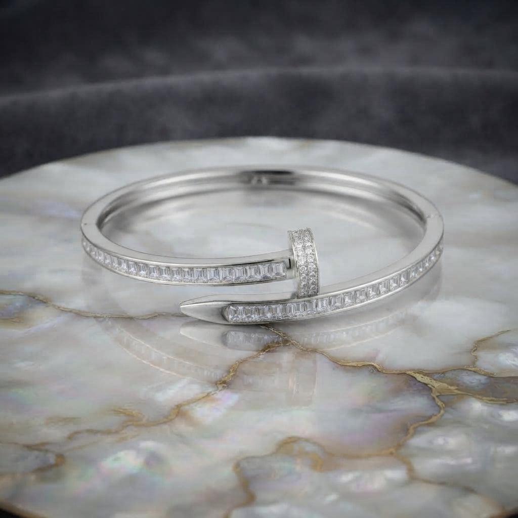 Silver-tone baguette CZ nail bypass bangle with channel-set stones and pointed tip