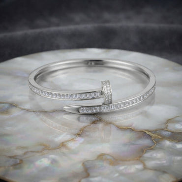 Silver-tone baguette CZ nail bypass bangle with channel-set stones and pointed tip