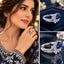 Collage showing a model wearing a silver-tone blue oval floral halo ring alongside two product close-ups.