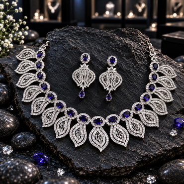 Silver-tone AD necklace with navy blue oval halo centres and pointed openwork leaf fringe, with matching teardrop-finish earrings.