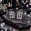 Pair of silver-tone upright rectangular earrings with clear-looking accent borders and intertwined letter-like openwork centres.