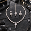 Silver-tone clear-looking leaf-link necklace with a halo-framed teardrop centre and small drop, with matching floral-top earrings and teardrop bindia.