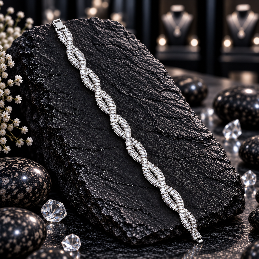 Silver-tone bracelet with repeating intertwined open loops, rows of clear rectangular accents and small round-accent connecting details.