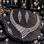 Silver-tone necklace, long tiered earrings and chain bindia with clear rectangular accents and cascading clear teardrop details.
