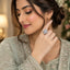 Silver-Tone CZ Pavé Four-Petal Flower Blossom Cocktail Statement Ring worn by model in Pakistani sage green bridal attire with floral hair accessory