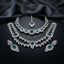 Silver-tone set with two necklaces, matching earrings, and maang tikka, featuring green and clear faceted accents.