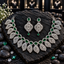 Silver-tone AD necklace with green oval halo centres and pointed openwork leaf fringe, with matching teardrop-finish earrings.