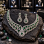 Silver-tone scalloped necklace with green oval centres and a teardrop centrepiece, with matching square-top teardrop earrings.