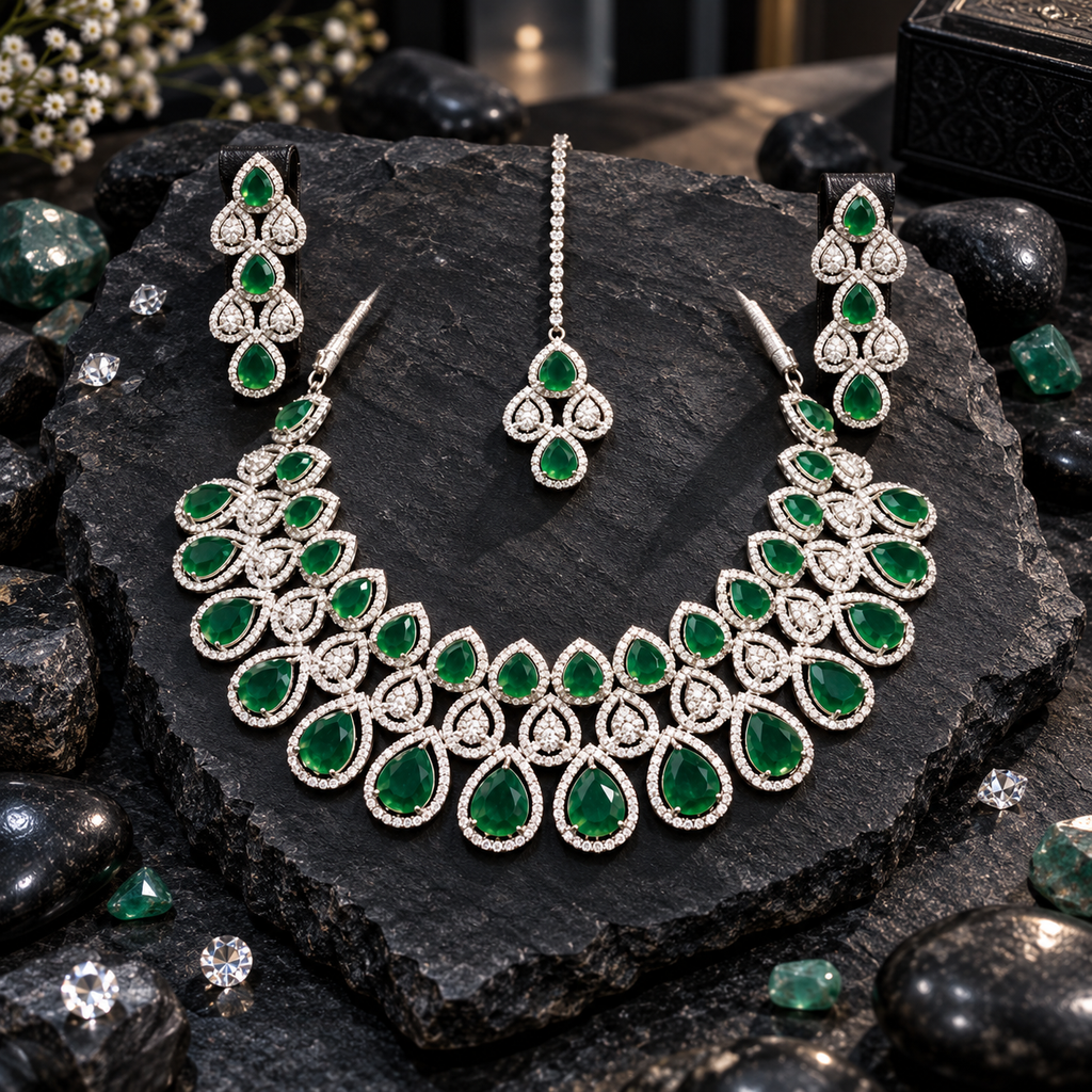 Silver-tone necklace with graduated green halo teardrops and clear-looking teardrop clusters, matching elongated earrings and a green chain bindia.