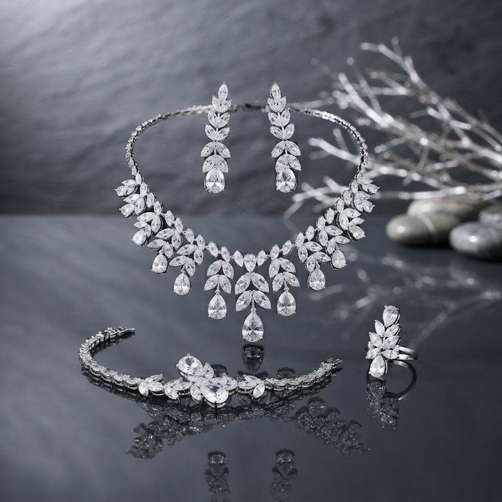 Silver-Tone Marquise and Pear CZ Leaf Spray 4-Piece Bridal Jewelry Set worn by model in black embroidered velvet bridal outfit in Mughal carved wooden arch setting showing full set with collar necklace drop earrings marquise CZ bracelet and cocktail ring in editorial bridal portrait
