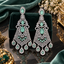 Pair of silver-tone chandelier earrings with mint-green and clear faceted accents and dangling teardrop details.