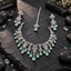 Silver-tone loop-floral necklace with mint green halo teardrop fringe, matching openwork triple-drop earrings and a single-drop chain bindia.