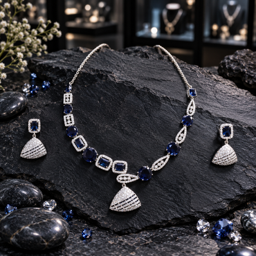Silver-tone necklace with navy blue accents, asymmetric rectangle and open teardrop links, a clear-looking striped fan pendant and matching earrings.