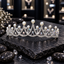 Silver-tone tiara with clear-accent scalloped arches, white pearl-look beads, graduated peaks and small rainbow-reflective accents.