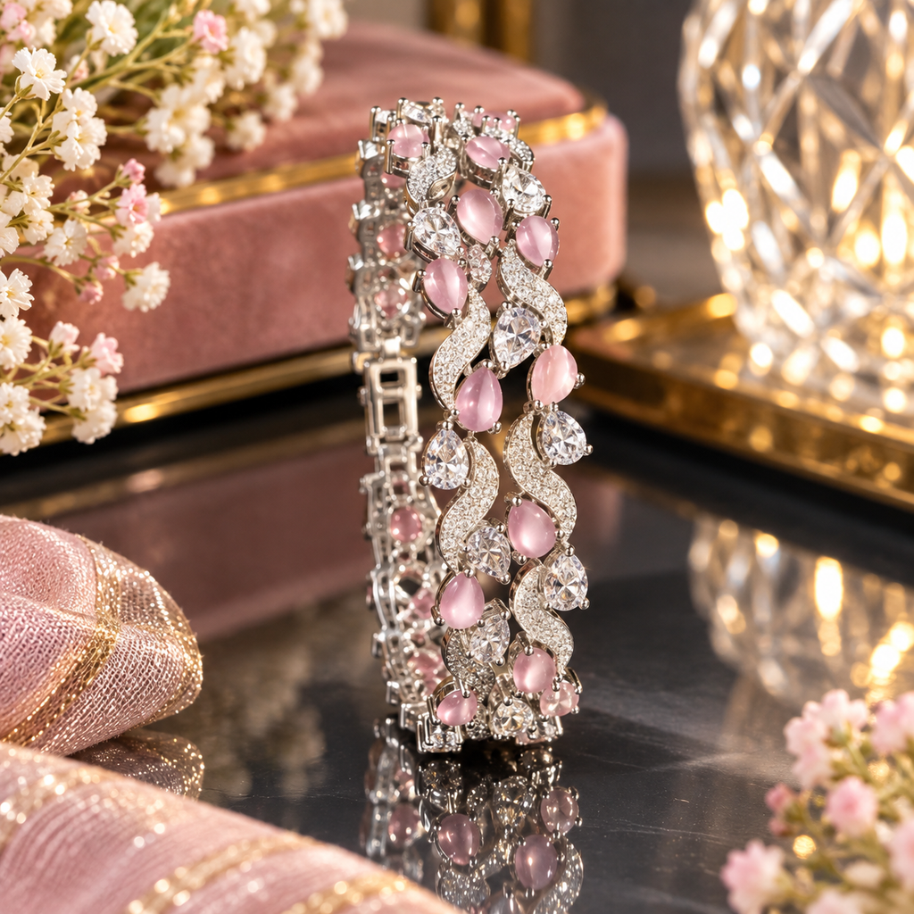 Silver-tone bracelet with pink oval accents and clear faceted details.