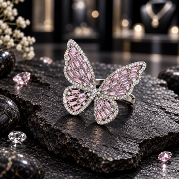 Silver-tone butterfly ring with pink rectangular and tapered wing accents, clear round borders and a clustered clear-looking centre.