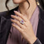 Rose Gold-Tone Pink Emerald-Cut CZ Four-Petal Floral Halo Cocktail Ring worn by model in grey velvet blazer and lavender top