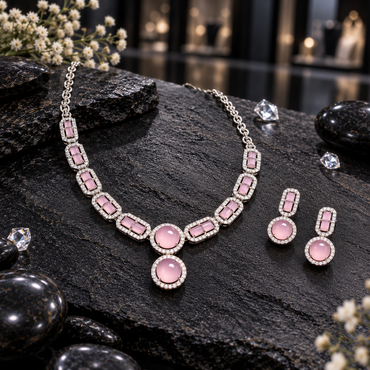 Silver-tone necklace and matching earrings with rectangular pink accents, rounded pink drops and clear sparkling borders.