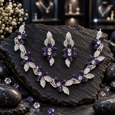 Silver-tone floral vine necklace with purple oval petals, clear-looking flower centres and decorative leaves, with matching elongated earrings.