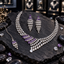 Silver-tone necklace, long tiered earrings and chain bindia with purple rectangular accents and cascading clear teardrop details.