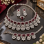Silver-tone red AD set with a necklace, earring pair, bracelet and ring, featuring bordered rectangular red accents and clear floral-style drops.