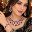 Model wearing a silver-tone red accent necklace, tiered earrings and matching bracelet with rectangular red details and clear-accent clusters.
