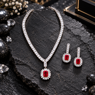 Silver-tone clear-accent necklace with a red rectangular pendant and radiating halo, alongside matching red rectangle drop earrings.