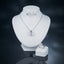 Silver-tone set displayed with a square-cut pendant necklace, round stud earrings, and a matching ring.