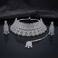 Silver White CZ Grand Pear Lattice Choker Necklace Earrings and Maang Tikka Bridal Set on dark mirror surface with satin backdrop showing rhodium silver wide micro-pave choker with pear lattice arches matching chandelier earrings and maang tikka