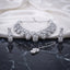 Silver White CZ Peacock Feather Filigree Choker Earrings and Maang Tikka Bridal Set flat lay on dark marble with white ivory satin backdrop showing rhodium silver 3-piece bridal set with peacock feather open filigree choker drop earrings and maang tikka