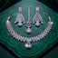 Silver White CZ Tiered Waterfall Pear Choker Necklace Earrings & Maang Tikka Bridal Set on green malachite tray with dark green velvet backdrop